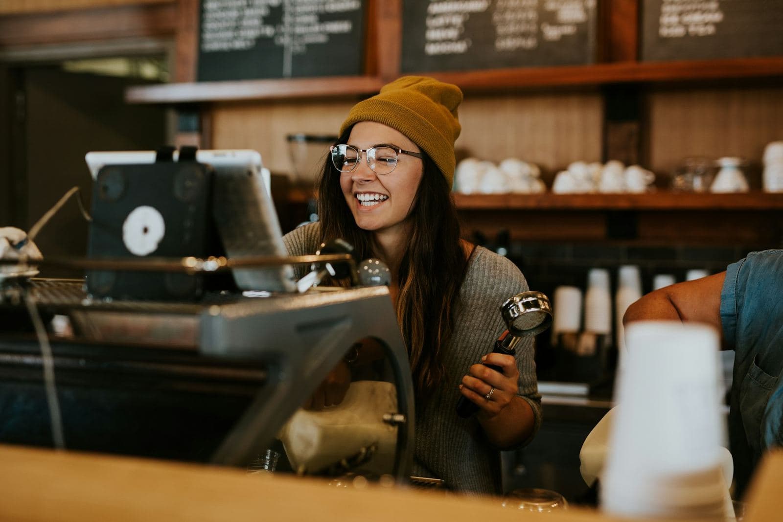 A smiling barista behind the counter