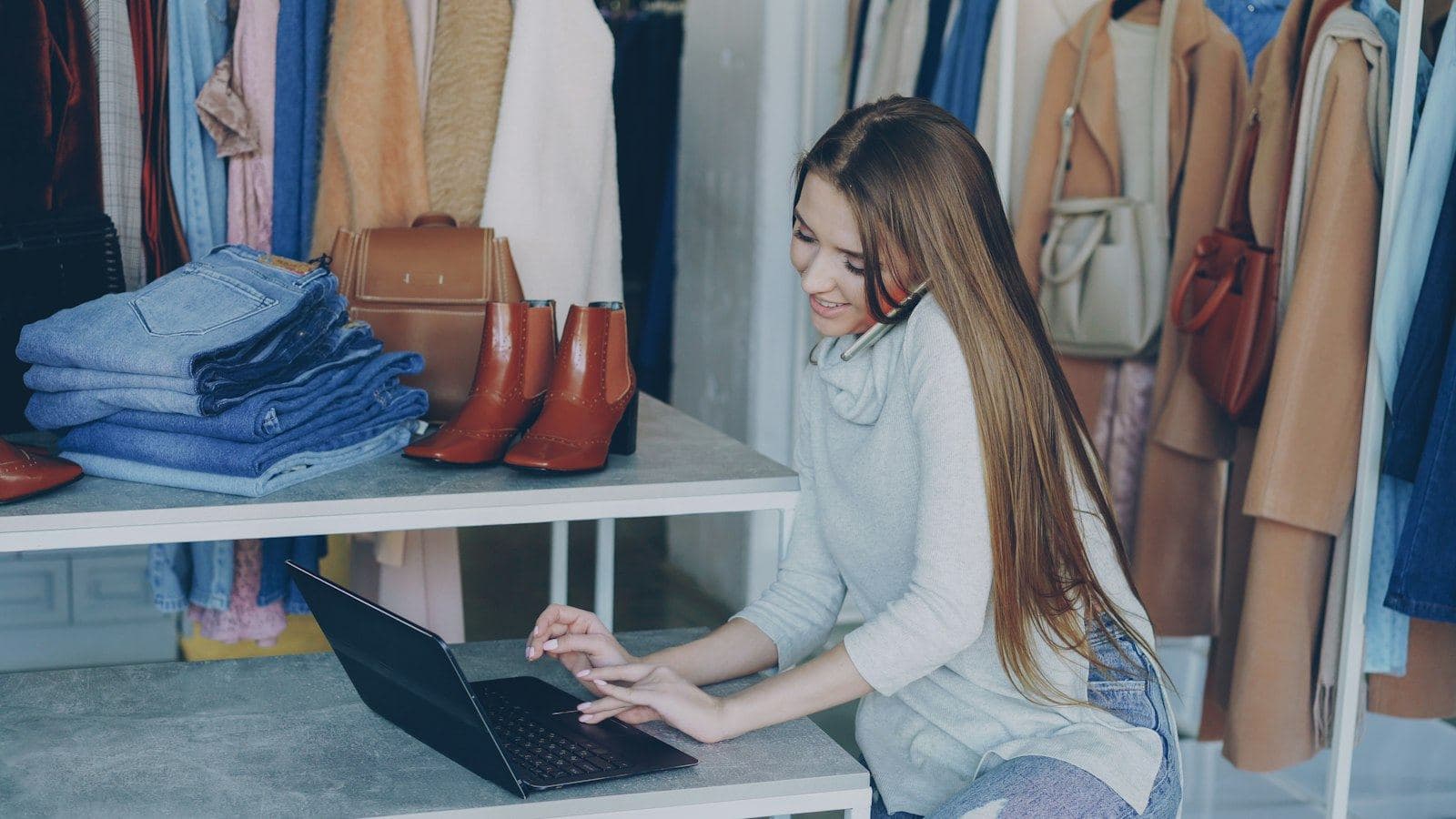 A boutique owner working on a laptop