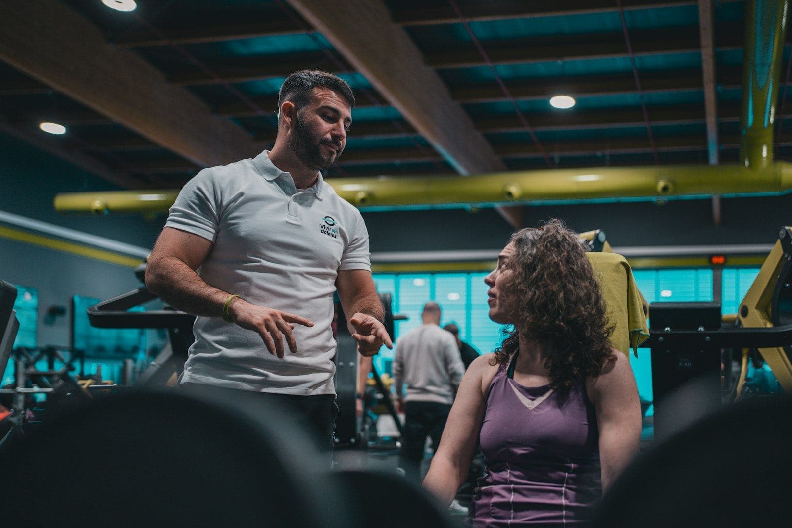A trainer talking with a member at the gym