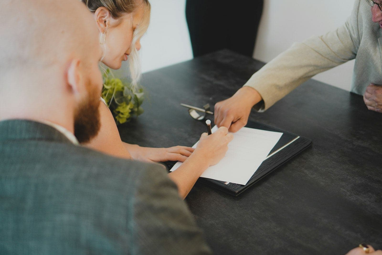 An agent and a client signing papers