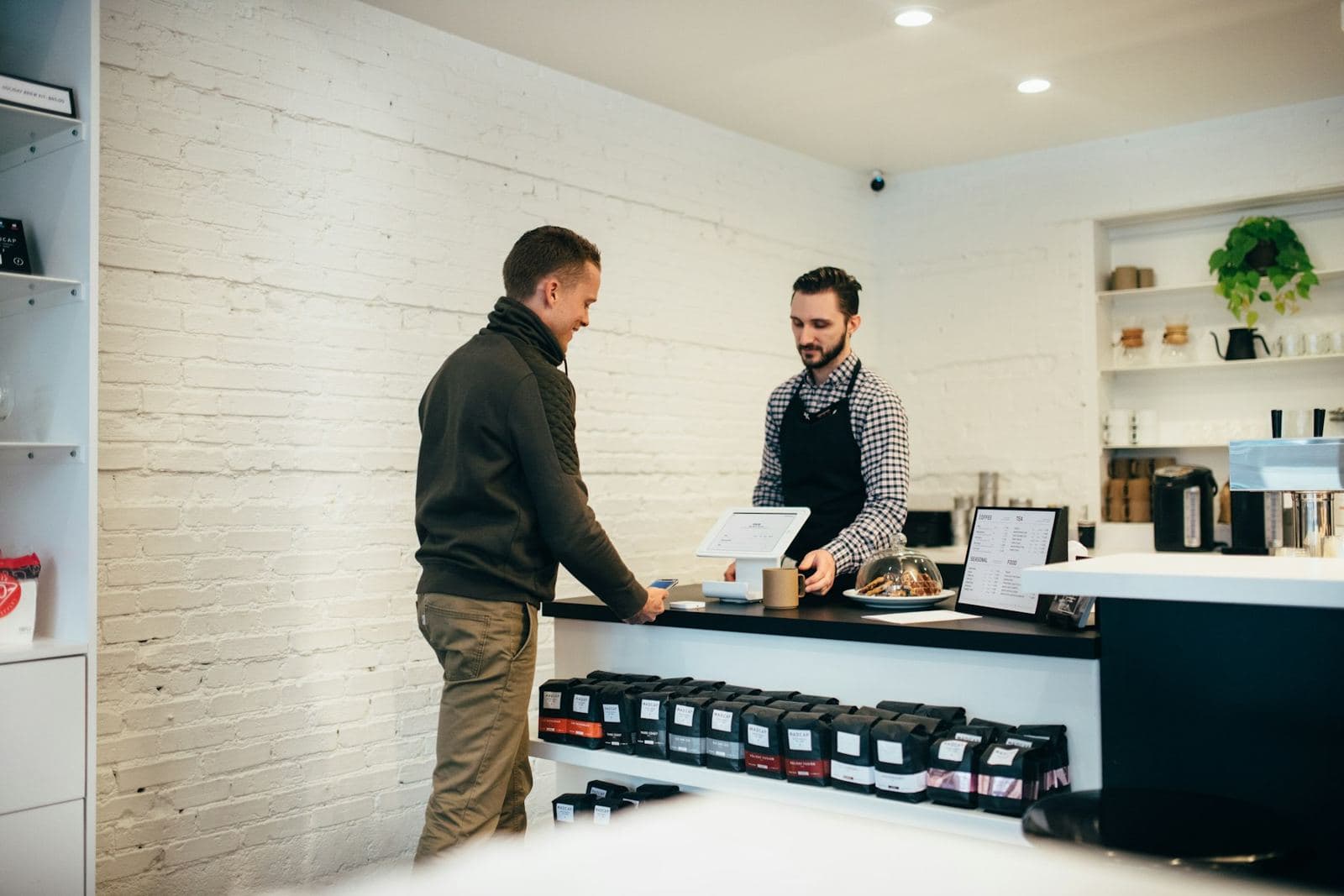 A shop counter with a customer being served