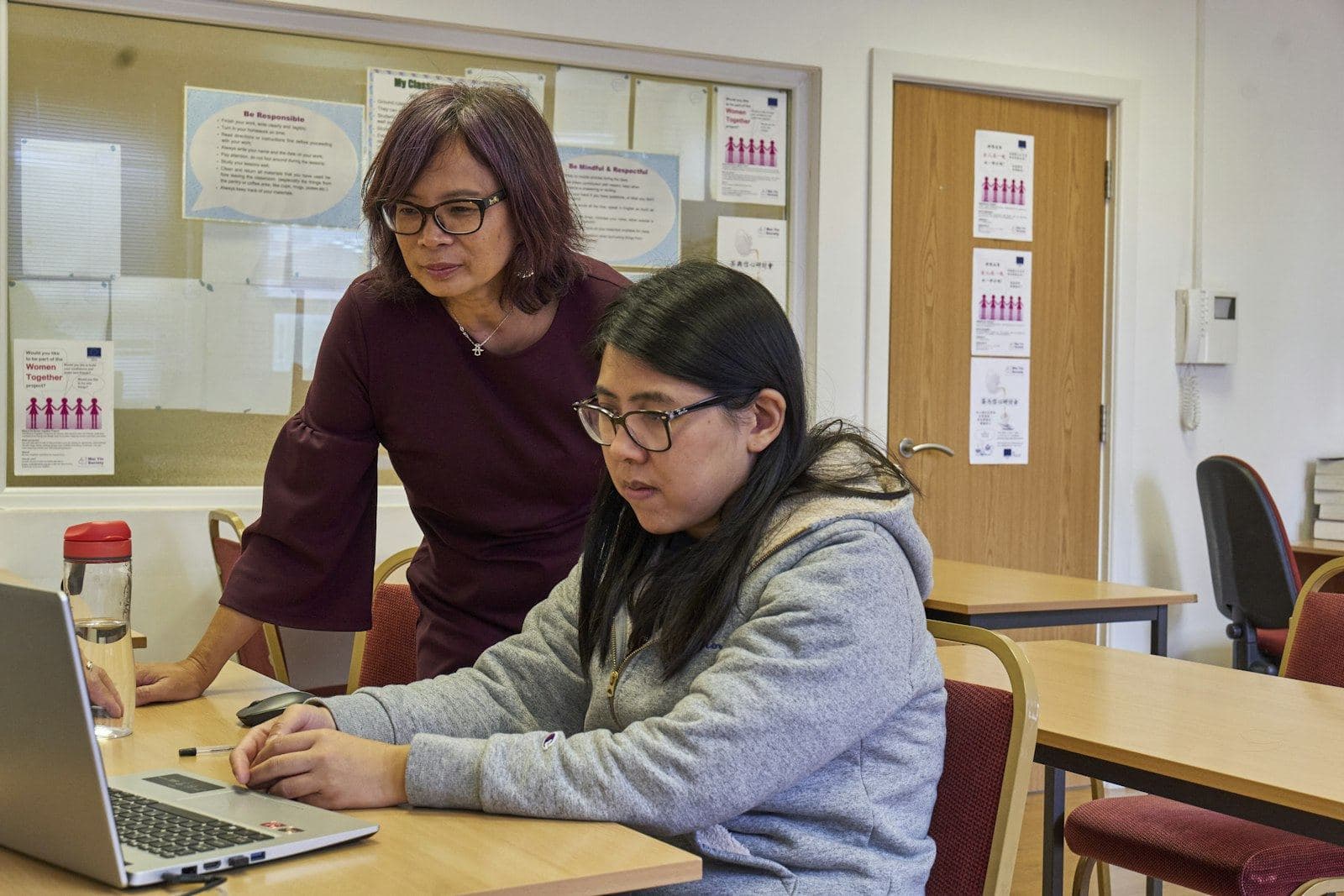A tutor working on a laptop